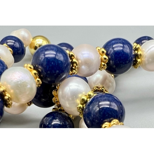 476 - A Cultured Pearl and Lapis Lazuli Matinee Length Necklace. 8mm lapis and pearls. Gilded spacers and ... 