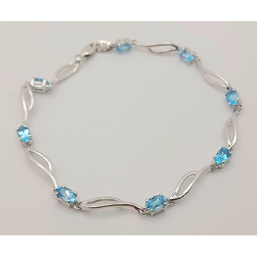 48 - A 9K White Gold Blue Topaz Bracelet. Eight ice-blue topaz gemstones. 18cm. 4.57g total weight