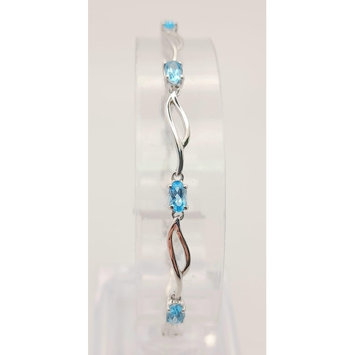 48 - A 9K White Gold Blue Topaz Bracelet. Eight ice-blue topaz gemstones. 18cm. 4.57g total weight