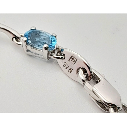 48 - A 9K White Gold Blue Topaz Bracelet. Eight ice-blue topaz gemstones. 18cm. 4.57g total weight