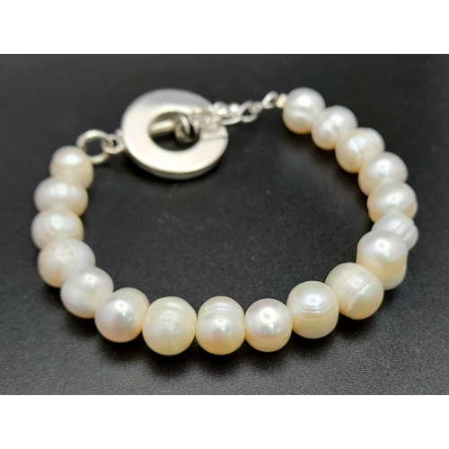 618 - A Sterling Silver Baroque Pearl T-Bar Bracelet 20cm Length. Largest Pearl 1cm Wide
