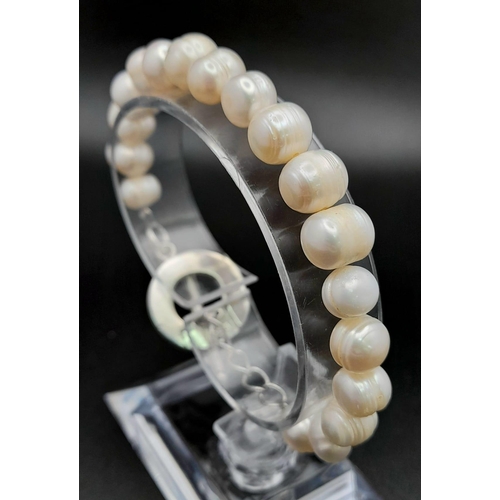 618 - A Sterling Silver Baroque Pearl T-Bar Bracelet 20cm Length. Largest Pearl 1cm Wide