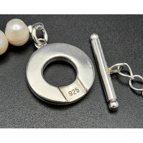 618 - A Sterling Silver Baroque Pearl T-Bar Bracelet 20cm Length. Largest Pearl 1cm Wide