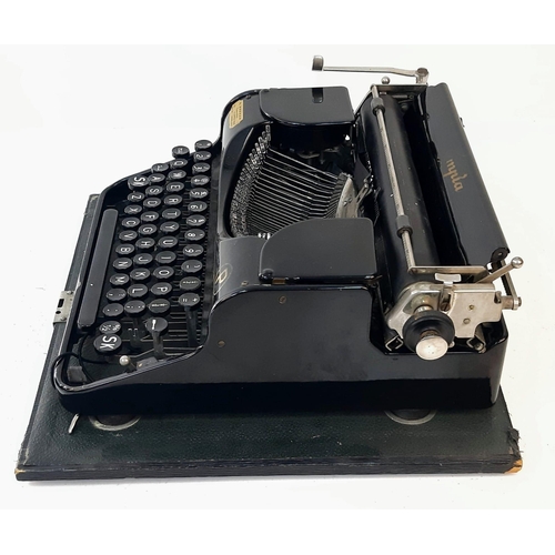 646 - A Vintage 1940s Olympia Progress Typewriter with Case. In worker order - case is slightly temperamen... 