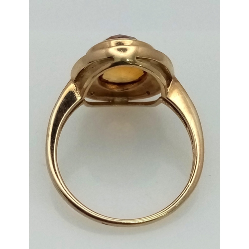 387 - A 9K Yellow Gold Citrine and Diamond Ring. Central faceted, rich, clean citrine with a diamond halo.... 