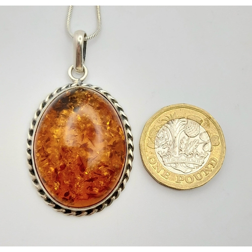 611 - A Vintage Large Silver Amber Cabochon Pendant Necklace. Pendant measures 5cm Drop from 46cm Sterling... 