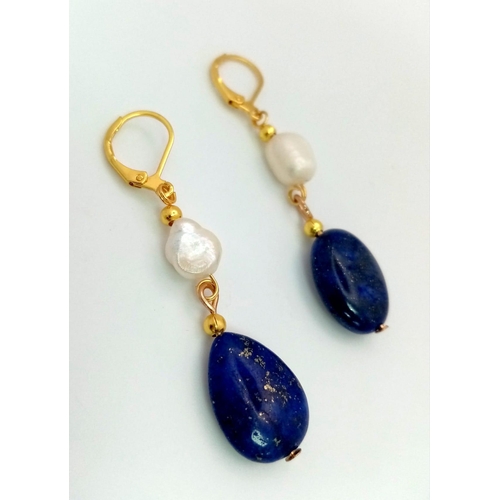 940 - A Pair of Lapis Lazuli and Cultured Baroque Pearl Drop Earrings. Gilded clasp. 4cm drop