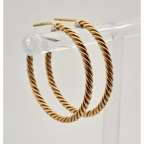 942 - A Pair of 9K Yellow Gold Twist Hoop Earrings. 3.87g