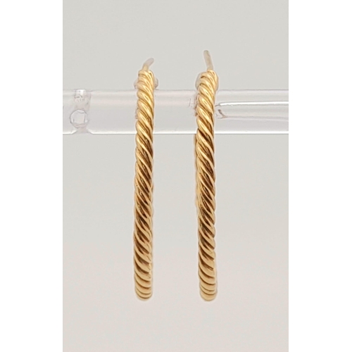 942 - A Pair of 9K Yellow Gold Twist Hoop Earrings. 3.87g