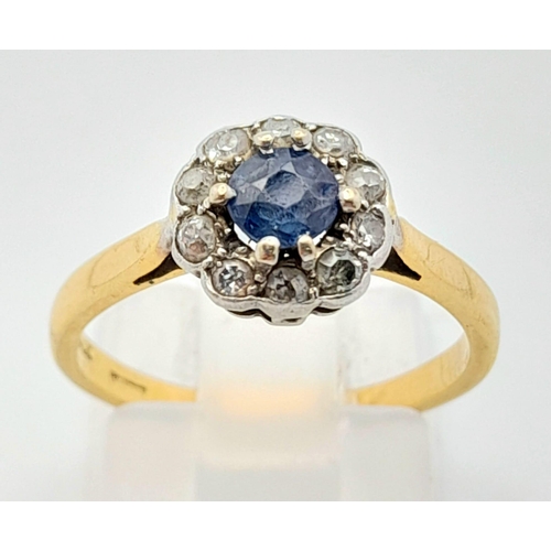 408 - A Vintage 18K Yellow Gold Sapphire and Diamond Ring. Central sapphire with a halo of diamonds. Size ... 