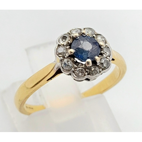 408 - A Vintage 18K Yellow Gold Sapphire and Diamond Ring. Central sapphire with a halo of diamonds. Size ... 