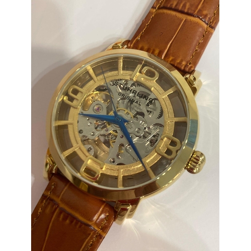 49 - Genuine STUHRLING of NEW YORK AUTOMATIC SKELETON WATCH. Blue hands model finished in gold plated sta... 