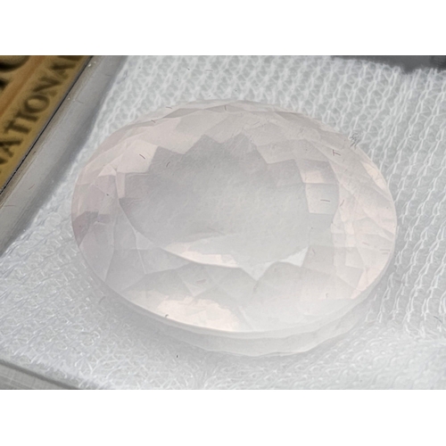 933 - A 50.33ct Madagascan Rose Quartz Oval Gemstone. AGI American Lab Certified. Comes in a sealed contai... 
