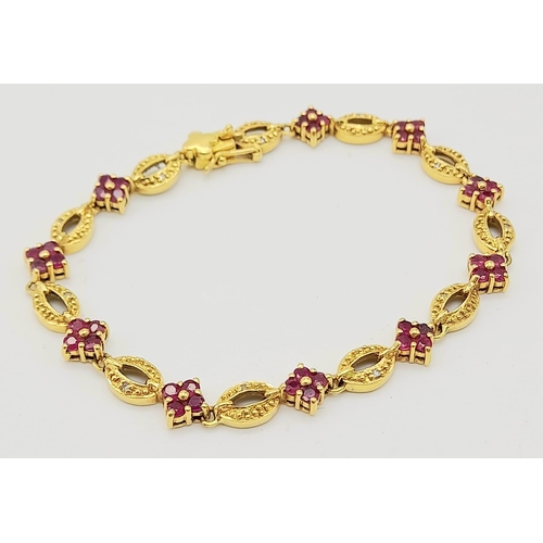 30 - 18K YELLOW GOLD RUBY SET BRACELET. TOTAL WEIGHT 11.26G