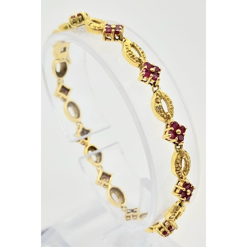 30 - 18K YELLOW GOLD RUBY SET BRACELET. TOTAL WEIGHT 11.26G