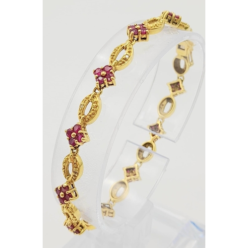 30 - 18K YELLOW GOLD RUBY SET BRACELET. TOTAL WEIGHT 11.26G