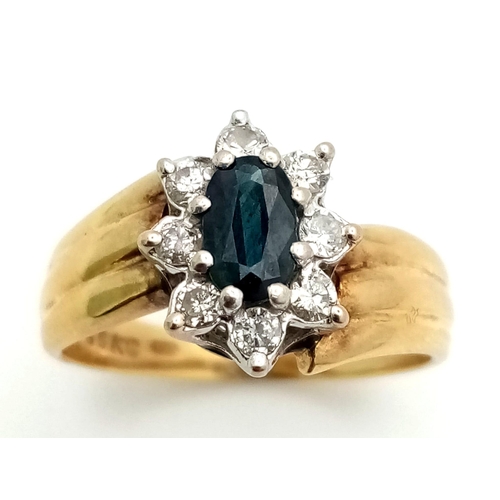 1626 - A DESIGNER 18K GOLD RING WITH CENTRAL SAPPHIRE SURRONDED BY A HALO OF DIAMONDS .  5.5gms   size O