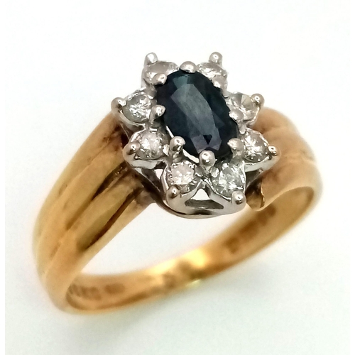 1626 - A DESIGNER 18K GOLD RING WITH CENTRAL SAPPHIRE SURRONDED BY A HALO OF DIAMONDS .  5.5gms   size O