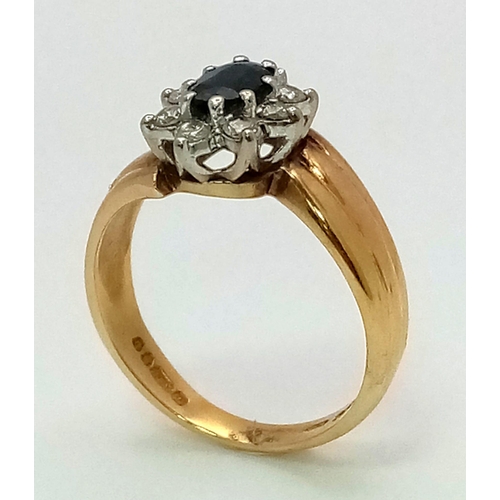 1626 - A DESIGNER 18K GOLD RING WITH CENTRAL SAPPHIRE SURRONDED BY A HALO OF DIAMONDS .  5.5gms   size O