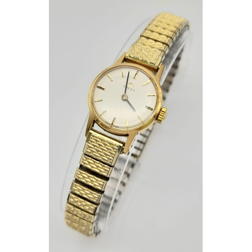 11 - A Vintage 1969 Omega 9K Gold Ladies Watch. Expandable gold-plated bracelet. 9k gold case - 20mm. Whi... 