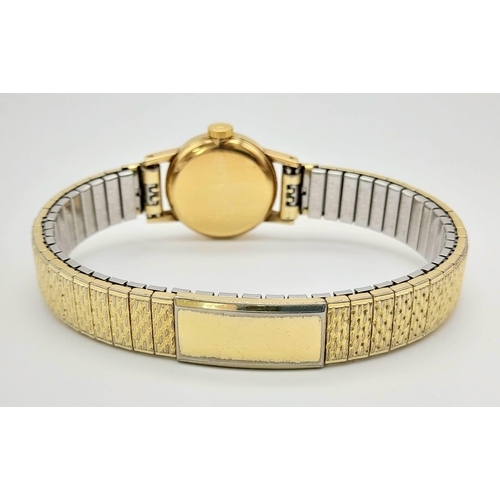 11 - A Vintage 1969 Omega 9K Gold Ladies Watch. Expandable gold-plated bracelet. 9k gold case - 20mm. Whi... 