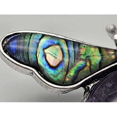 444 - An Amethyst Bee Brooch with Decorative Shell Wings. Wingspan - 5cm. On white metal.