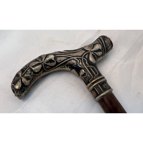 613 - An Antique Irish Fiddleback Mahogany Walking Stick with Decorative Silver Handle. 90cm total length.