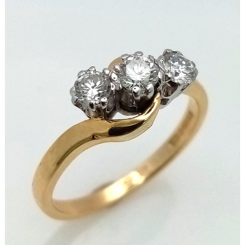 776 - AN 18K GOLD DIAMOND TRILOGY RING IN CROSS OVER STYLE WITH 0.8ct OF QUALITY DIAMONDS .   3.9gms   siz... 
