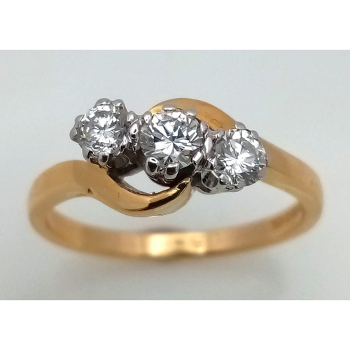 776 - AN 18K GOLD DIAMOND TRILOGY RING IN CROSS OVER STYLE WITH 0.8ct OF QUALITY DIAMONDS .   3.9gms   siz... 