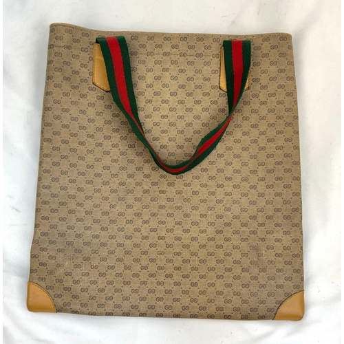 155 - A Gucci Monogram Small Canvas Tote Bag. Monogram exterior with leather trim and red and green cloth ... 