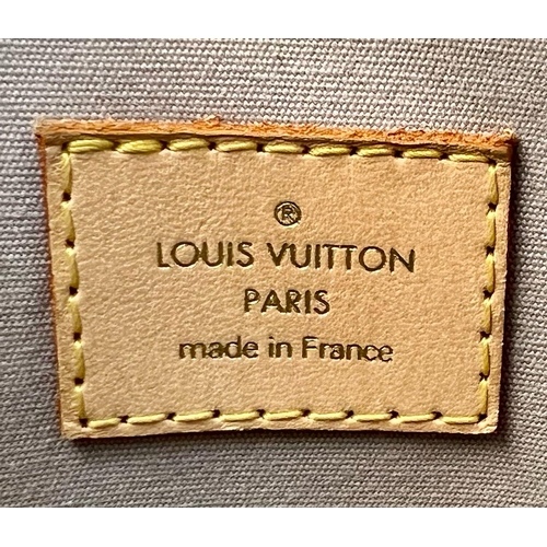 A Louis Vuitton Lockit Monogram Gold-Tone Mirrored Vinyl…