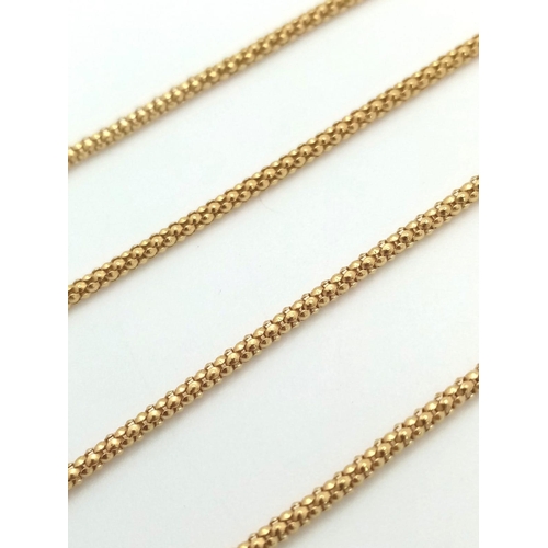 774 - AN 18K GOLD AND AMBER PENDANT ON AN 18K GOLD 58cms  TWIST CHAIN .   8.1gms
