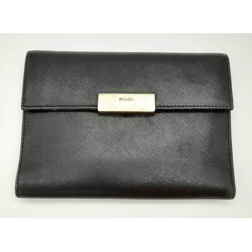 932 - A Prada Black Leather Wallet. Please see photos for conditions. 14cm x 10cm. Ref: 13106