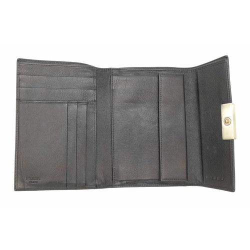 932 - A Prada Black Leather Wallet. Please see photos for conditions. 14cm x 10cm. Ref: 13106