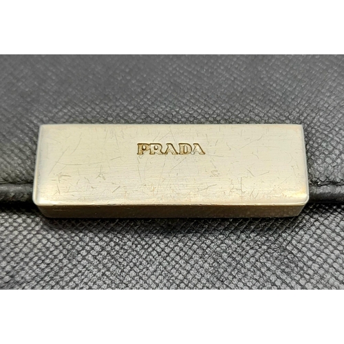 932 - A Prada Black Leather Wallet. Please see photos for conditions. 14cm x 10cm. Ref: 13106