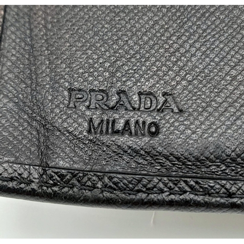 932 - A Prada Black Leather Wallet. Please see photos for conditions. 14cm x 10cm. Ref: 13106