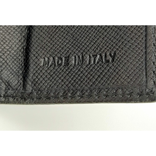 932 - A Prada Black Leather Wallet. Please see photos for conditions. 14cm x 10cm. Ref: 13106