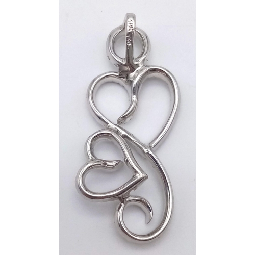 925 - A DESIGNER HEAVY WHITE GOLD DIAMOND PENDANT .  5.9gms   3.8cms drop