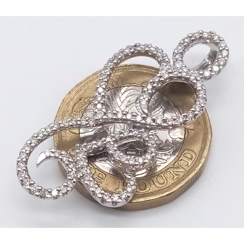 925 - A DESIGNER HEAVY WHITE GOLD DIAMOND PENDANT .  5.9gms   3.8cms drop