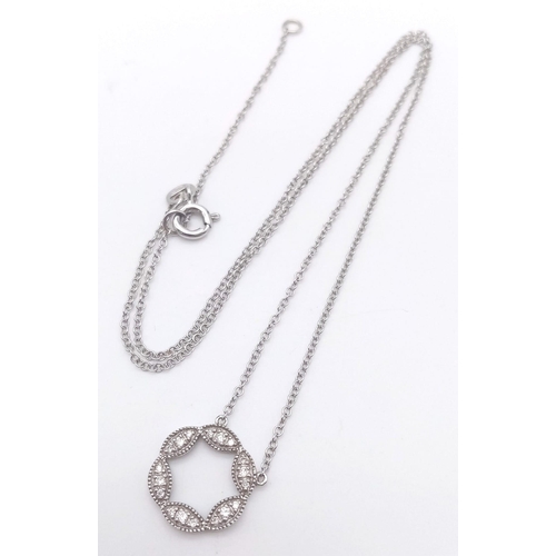 912 - A 9K WHITE GOLD AND DIAMOND PENDANT AND MATCHING EARRING SET .4.5gms
