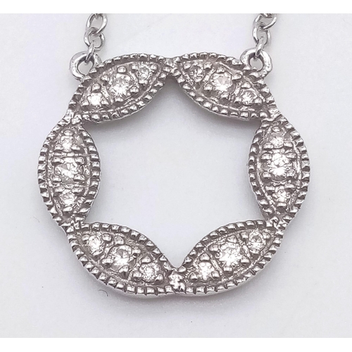 912 - A 9K WHITE GOLD AND DIAMOND PENDANT AND MATCHING EARRING SET .4.5gms