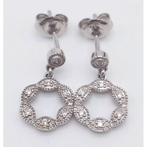 912 - A 9K WHITE GOLD AND DIAMOND PENDANT AND MATCHING EARRING SET .4.5gms
