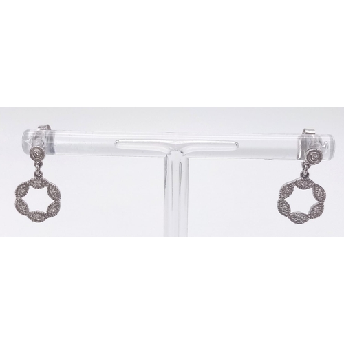 912 - A 9K WHITE GOLD AND DIAMOND PENDANT AND MATCHING EARRING SET .4.5gms
