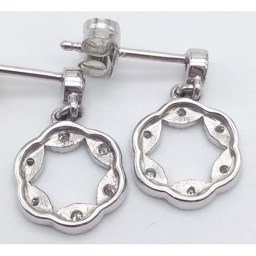 912 - A 9K WHITE GOLD AND DIAMOND PENDANT AND MATCHING EARRING SET .4.5gms