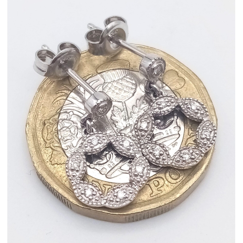 912 - A 9K WHITE GOLD AND DIAMOND PENDANT AND MATCHING EARRING SET .4.5gms
