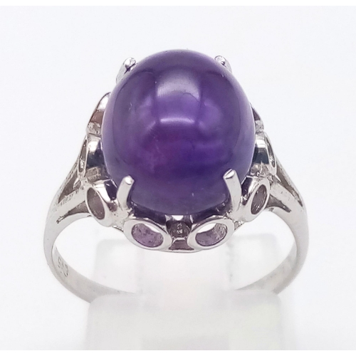 918 - AN AMETHYST CABOCHON SET IN 9K WHITE GOLD .  3.1gms   size N
