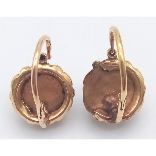 919 - A PAIR OF 18K ROSE GOLD EARRINGS WITH SAPPHIRE CENTRE STONES .2.2gms