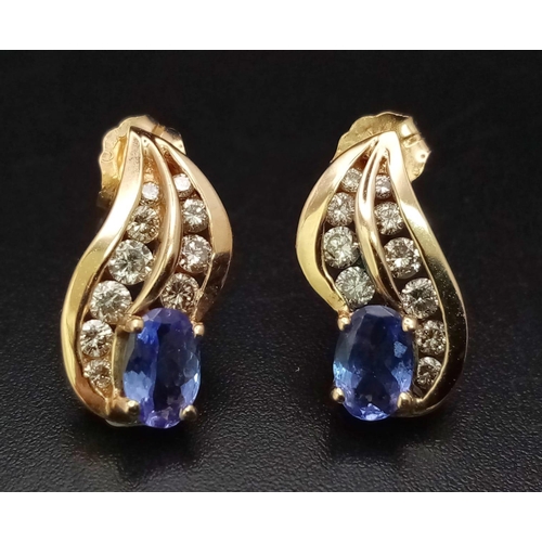 257 - AN ELEGANT PAIR OF DIAMOND AND TANZANITE EARRINGS SET IN 9K GOLD .    3.2gms       ref 13068