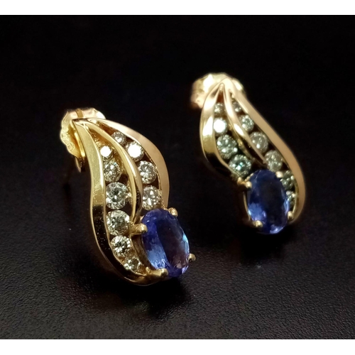 257 - AN ELEGANT PAIR OF DIAMOND AND TANZANITE EARRINGS SET IN 9K GOLD .    3.2gms       ref 13068