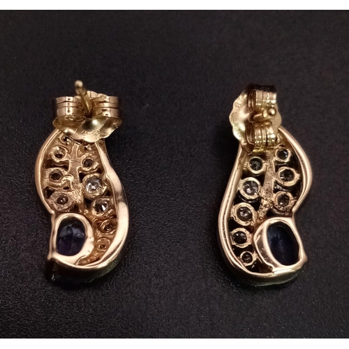 257 - AN ELEGANT PAIR OF DIAMOND AND TANZANITE EARRINGS SET IN 9K GOLD .    3.2gms       ref 13068